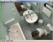 A low-resolution security type camera records a woman shitting on the toilet. No audio.